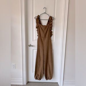 NWOT ADORABLE suede look romper! Size M. Open back with amazing frills!